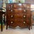 A very finely figured flame mahogany George III or “Hepplewhite" chest of drawers with book matched timber on the four...