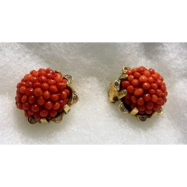 Elegant and collectible, these vintage Nettie Rosenstein clip-on earrings feature striking clusters of petite red coral...