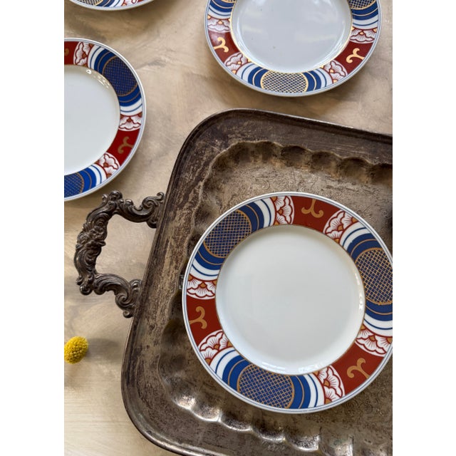 Elegant vintage set of four Fitz and Floyd Mishiki pattern 7.5” plates, featuring a refined border design in rich oxblood...