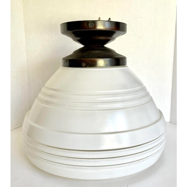 Here is a fantastic light fixture from the 1950's or earlier. The light features a large glass piece that is frosted with...