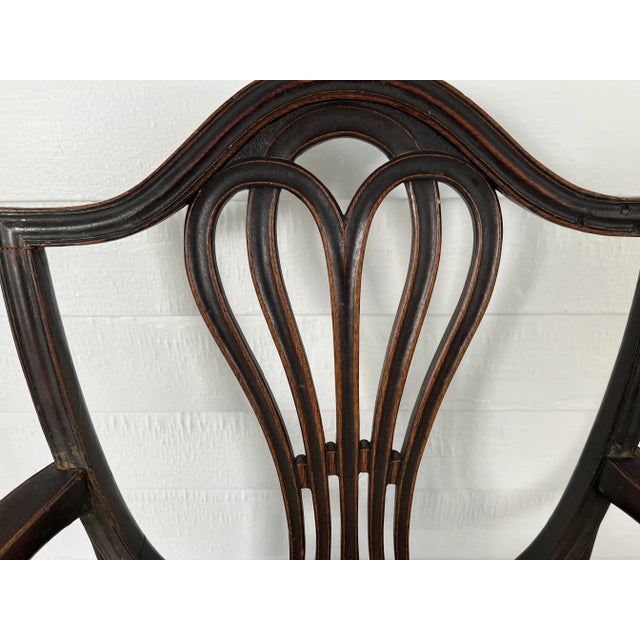 Antique Early 19th century American Federal ribbon back mahogany arm chair. Graceful carved back splat and elegant lines....