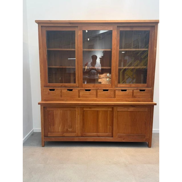 Bring warmth, functionality, and timeless craftsmanship into your interior with this impressive solid teak display...