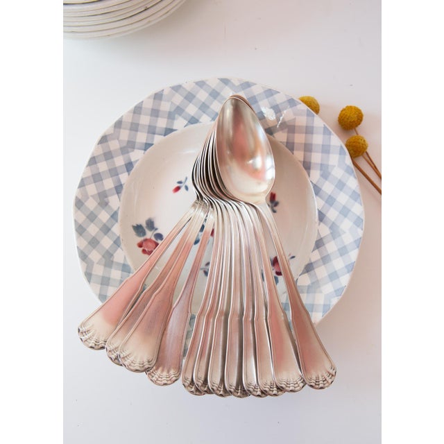 Set of 12 soup spoons by the prestigious French firm ERCUIS, Coquille pattern, with 84 g silver plating. The silver...