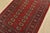 A tribal Bokhara rug hand-knotted with fine wool on a cotton foundation. This rug features rows of repeating medallions...