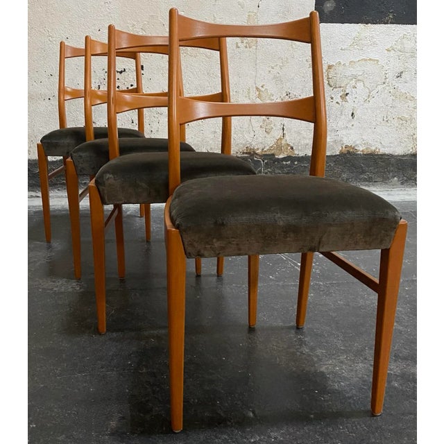 Set of four elegantly stylized Mid-Century Danish Modern dining chairs in beech hardwood. Reminiscent of Mid-Century...