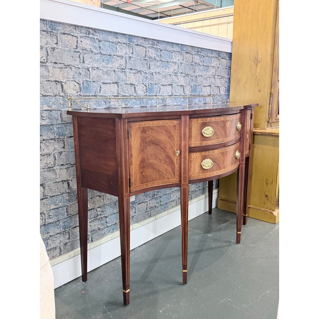 A finely crafted Henkel Harris sideboard showcasing timeless Hepplewhite inspired design and exceptional cabinetmaking...