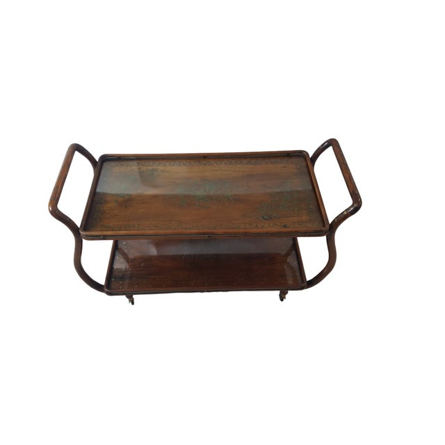 A fine Mid-Century aesthetic copper and brass inlaid tea cart or side table. The two galleried trays connected by a two...