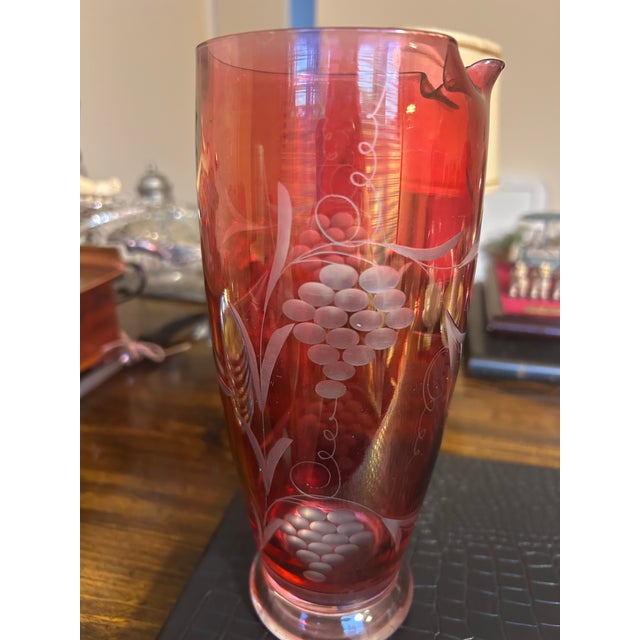 Antique Cranberry Glass etched with grapes and vines wine pitcher. Circa 1900's-1930's. Possibly crafted in Bohemia (Czech...
