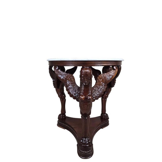 Vintage Indonesian Neoclassical Style Winged Caryatid Marble Top Center Table Decorative round table with a white marble...