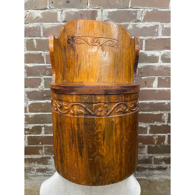 This traditional Scandinavian kubbestol is hand-carved from a single log with the center hollowed out to form the...