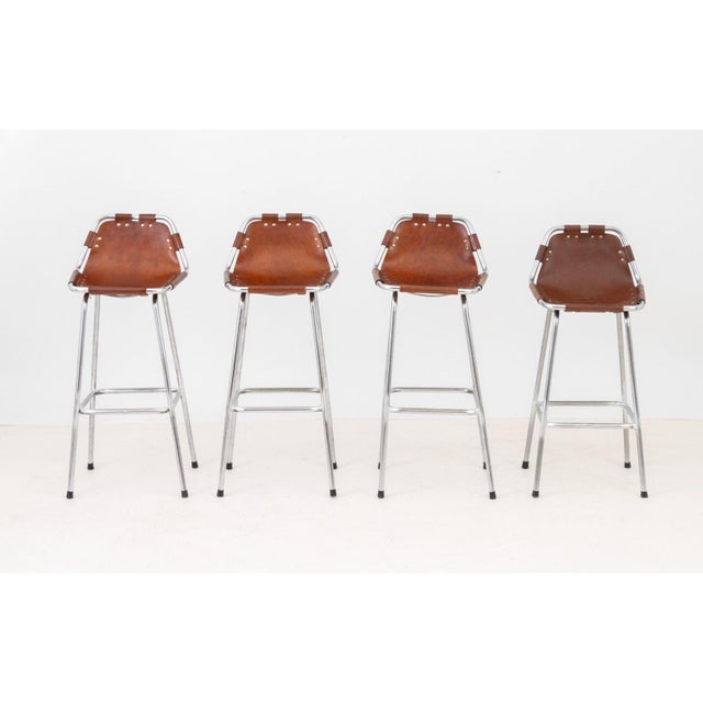 Charlotte Perriand (French, 1903-1999) Set of Four &nbsp;"Les Arcs" Bar Stools, brown leather seats on chrome-plated...