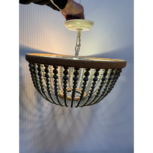 Design Plus Gallery presents the Beaded Drum Chandelier from Uolfin. This light fixture has strands of beads that go from...