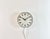 Metamec wall clock was made in United Kingdom during the 1970s. It features a white bakelite body with a chrome ring, an...