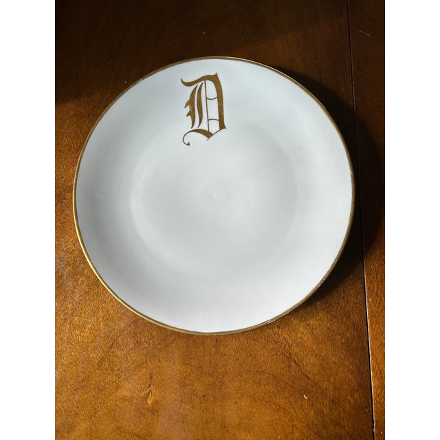 Large white round 13" monogrammed D platter, made in Germany. Trimmed in gold. Very good condition. Some wear on gold.