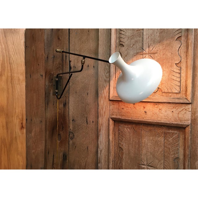 1950s articulated sconce that is a combination of painted metal and brass . This is great for lighting of art work.