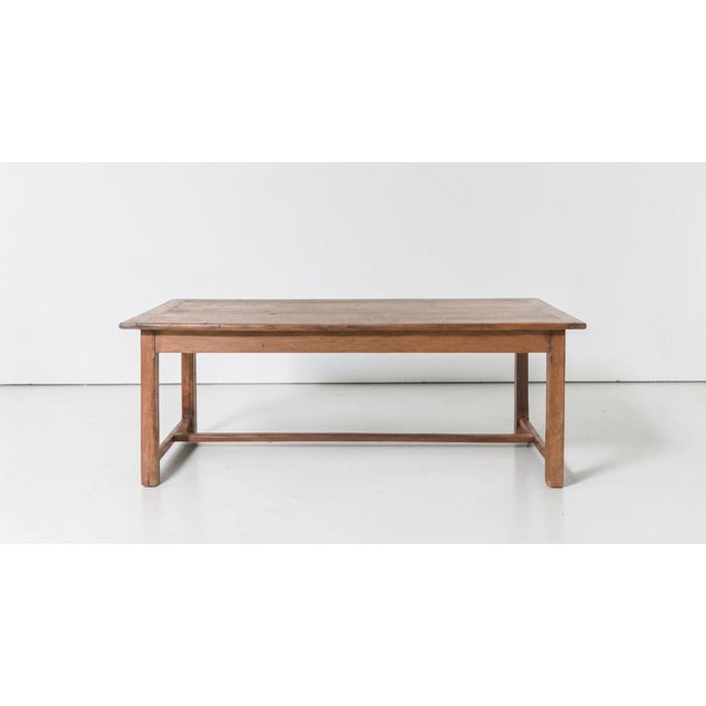 French Provincial solid oak farmhouse harvest table dating to the early to mid-19th century, featuring a beautifully aged...