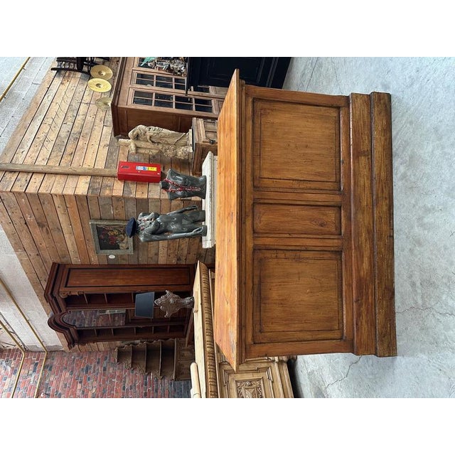 This pine counter has been completely restored. It features two doors on the back that open to reveal storage space, as...
