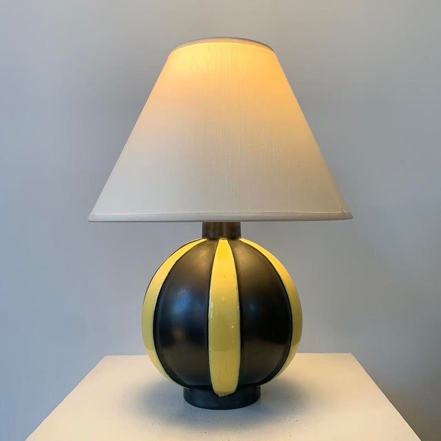 Decorative ceramic table lamp, circa 1950, France. Black and yellow striped enameled ceramic, new ivory fabric shade....