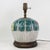 This antique table lamp is expertly crafted from an authentic porcelain vessel featuring the traditional and highly...