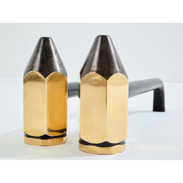 Here is a pair of vintage brass and wrought iron andirons designed by an unknown designer in the 1960s. The pencil is cast...