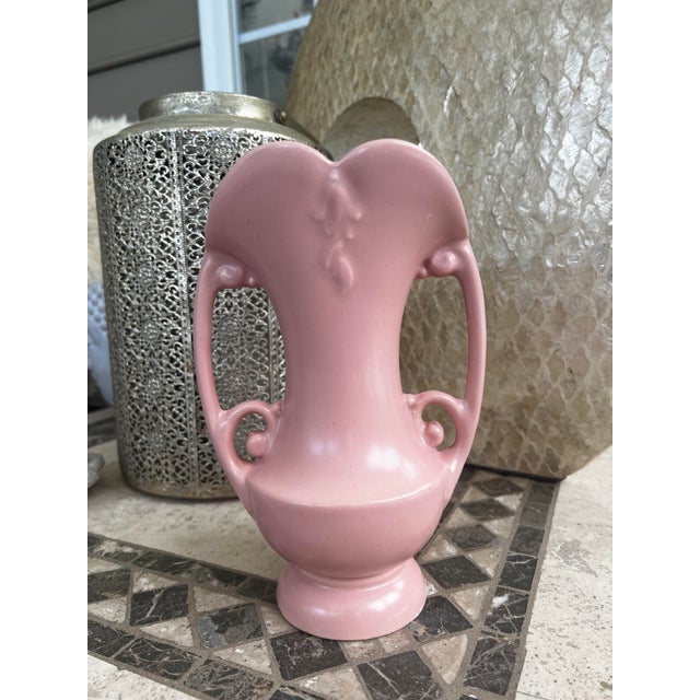 Jazz up your décor with this charming Art Deco Abingdon two-handled vase in a soft, delicate shade of light pink. Crafted...