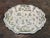 18th century polychrome French faience molded platter with scenes of gentry figures
