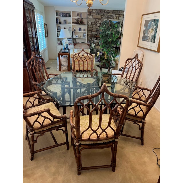Authentic McGuire Dining Set which includes 6 high back cathedral ratan Dining chairs with arms. These chairs designed by...
