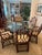 Authentic McGuire Dining Set which includes 6 high back cathedral ratan Dining chairs with arms. These chairs designed by...