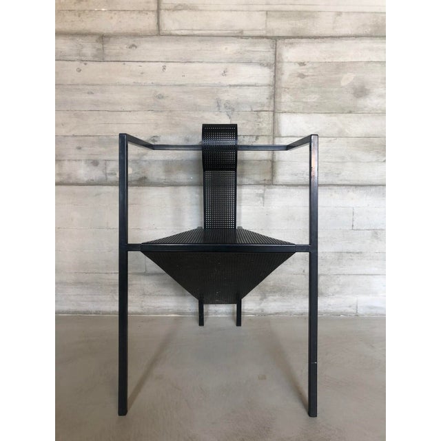 A striking and highly architectural occasional chair from the 1980s, embodying the bold geometric language of the...