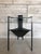 A striking and highly architectural occasional chair from the 1980s, embodying the bold geometric language of the...