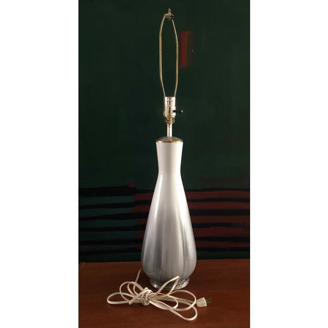 This vintage table lamp hails from the 60's and features a wonderful understated gray, white and gold tints. Uses regular...