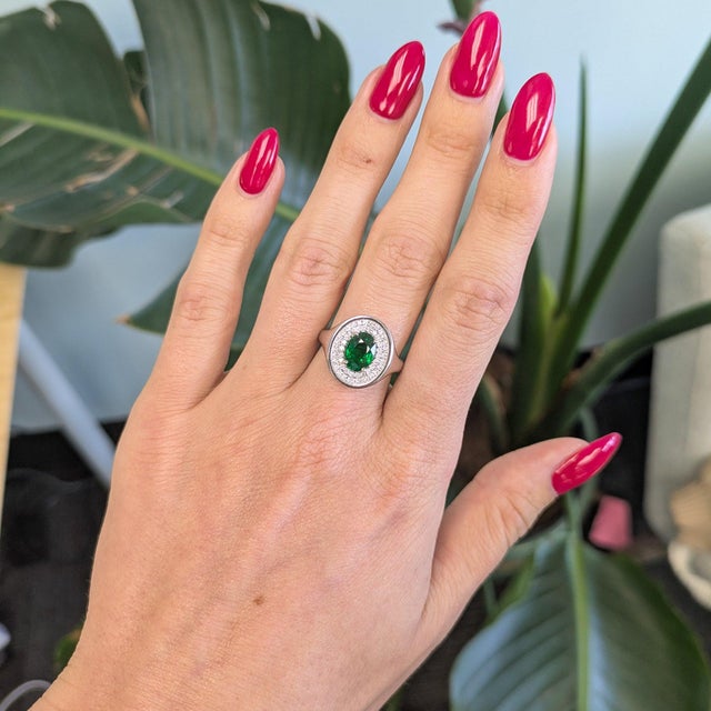 A 2.04-carat tsavorite garnet blazes in vivid, grass-green at the center of this solid 14K white gold ring, surrounded by...