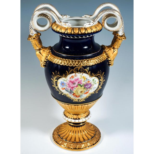 Double snake-handled vase in baluster form on mounted funnel-shaped base, handles raised at the sides in the form of...