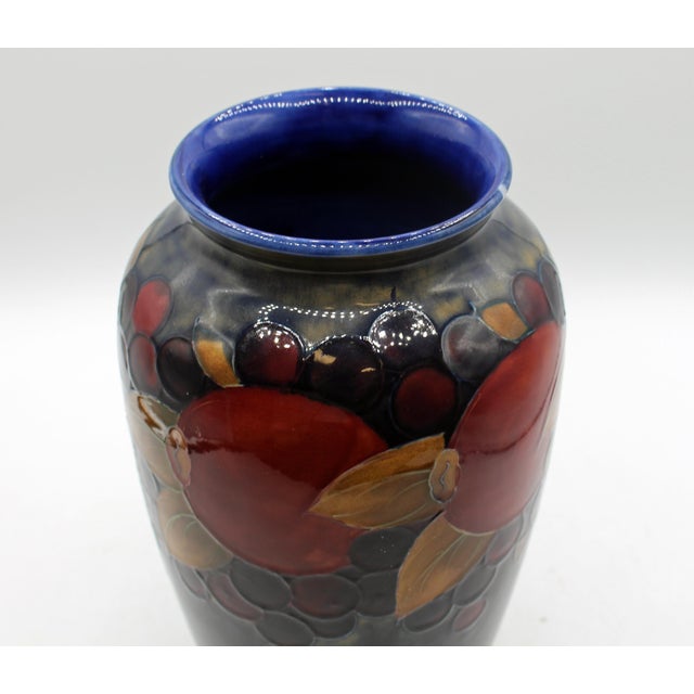 Circa 1930 large vase "Pomegranate" design by Moorcroft, England. Designed by William Moorcroft, the body festooned with...