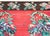 A cold vintage Turkish kilim rug with five large rose bouquet clusters in the center, set against a crimson background,...