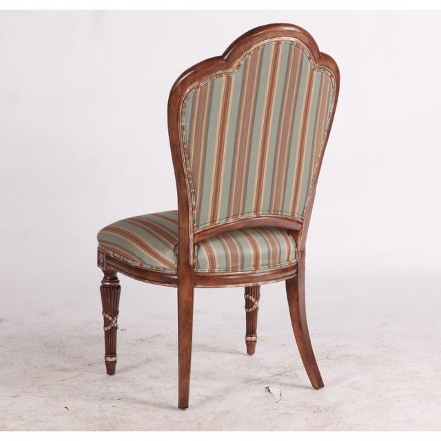 Oversized Louis XVI-style dining chairs by Ferguson Copeland, featuring exquisite carved wood frames with elegant...