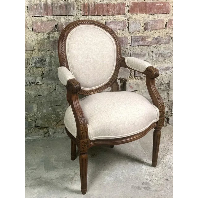 Children's armchair with louis XVI style medallion in carved drowning and lined fabric hungeed furnishing beige Made in...