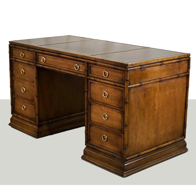 We love this 1970s Hollywood Regency Faux Bamboo Partner Desk by Sligh Furniture. It has a handsome black leather top...