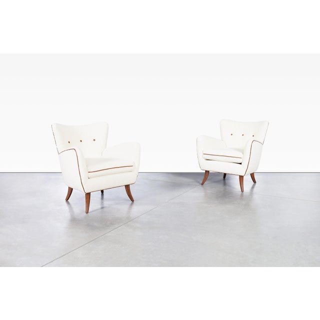 Mid-century modern lounge chairs designed by Austrian designer Ernst Schwadron in the 1940s, showcasing the graceful...