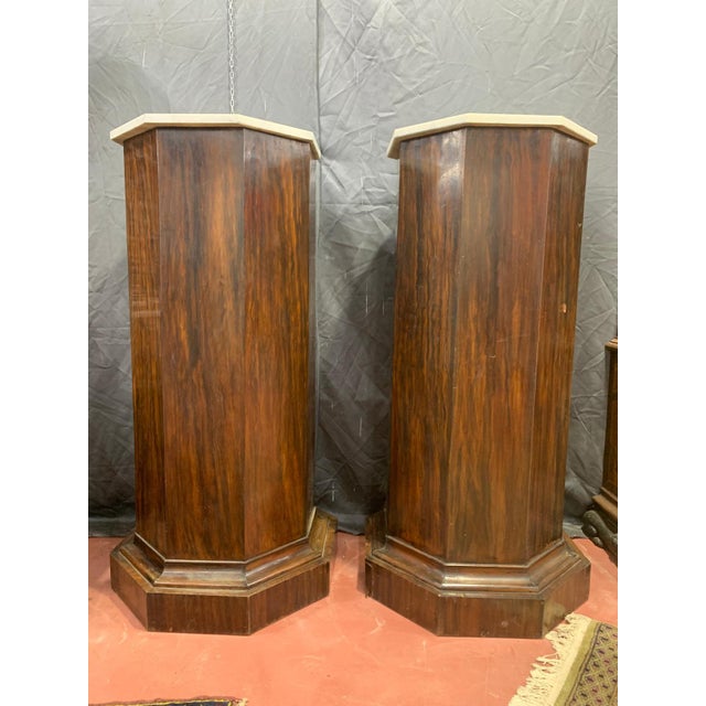 An antique pair of octagonal rosewood (pau ferro) columns This piece is attributed to the mentioned designer/maker. It has...