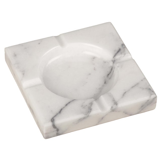 Handcrafted from richly veined white marble, the Naya Ashtray is defined by its clean square silhouette, recessed circular...