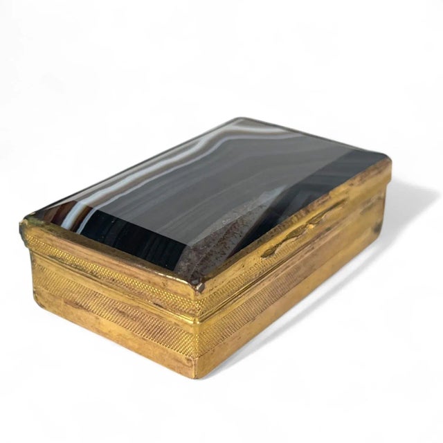 An 18th Century Austrian Gilt Bronze & Carved Agate Box The box has a rectangular shape with a hinged lid. The primary...