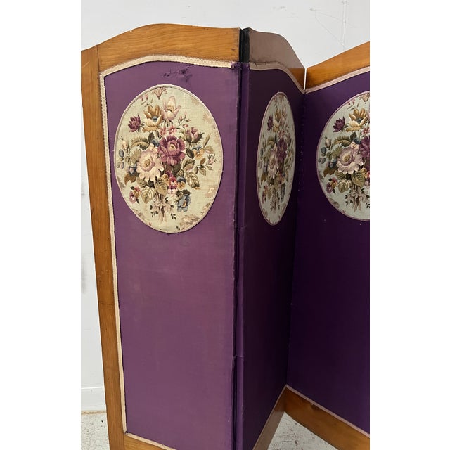 Four-panel screen in wood and fabric Cherry wood frame Panels decorated with an oval in petit point tapestry Floral...