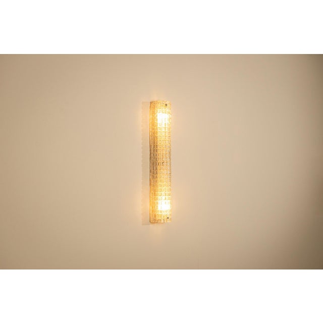 Italian lighting from the 1970s often combined architectural forms with exceptional glassmaking. This large wall lamp,...