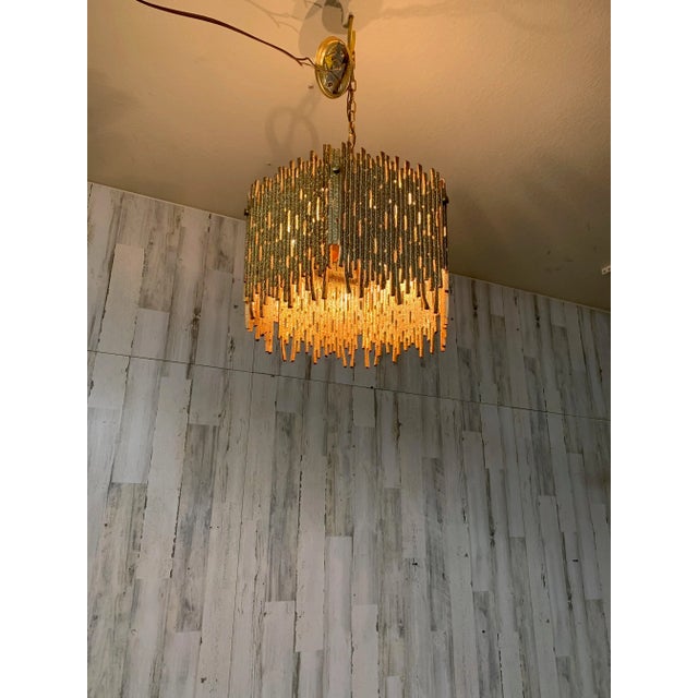 Golden brass brutal design pendant light for Moe lighting. Very intricate six sided chandelier with six light bulbs...
