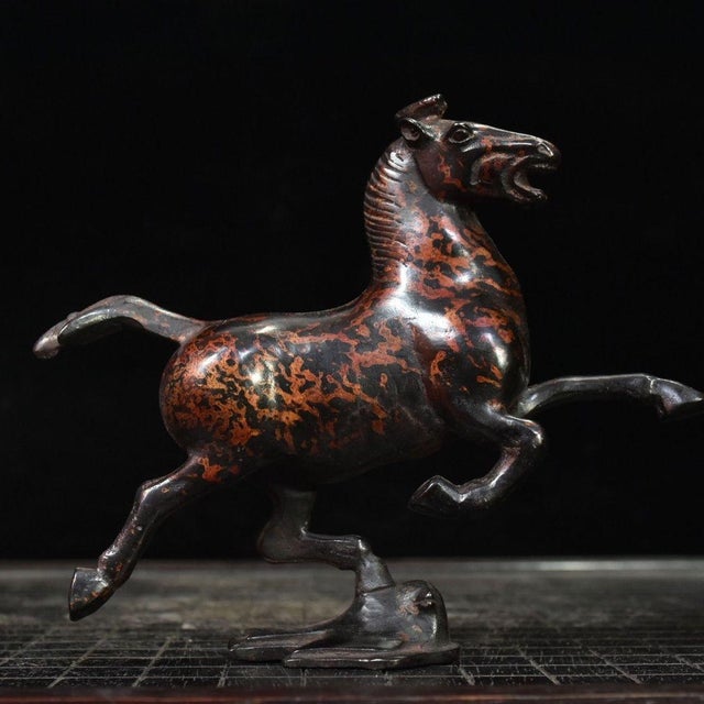 This cast bronze sculpture captures the celebrated galloping horse motif of the Eastern Han dynasty, popularly known as...