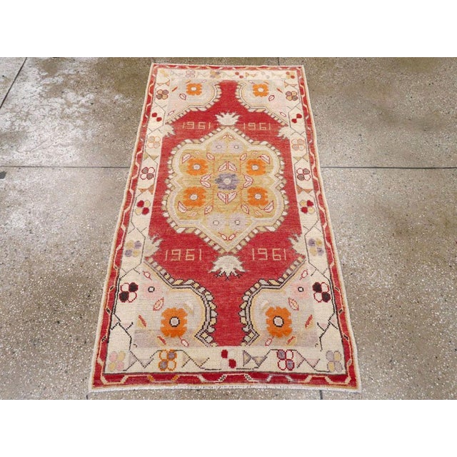 A vintage Turkish Oushak throw rug. Dated 1961 four times, this strawberry field scatter has a lobed and pendant medallion...