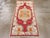 A vintage Turkish Oushak throw rug. Dated 1961 four times, this strawberry field scatter has a lobed and pendant medallion...