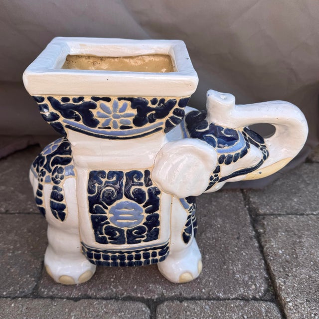Vintage Chinoiserie blue and white ceramic elephant planter features a hand painted design with a glazed finish. The...