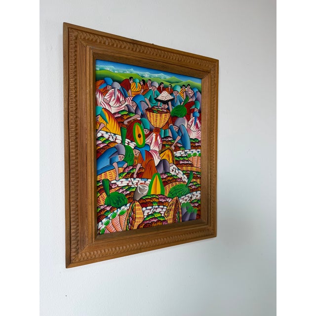 Vibrant 1970’s Haitian folk art oil on canvas painting by Carlo Decimus, depicting a lively fruit market scene filled with...